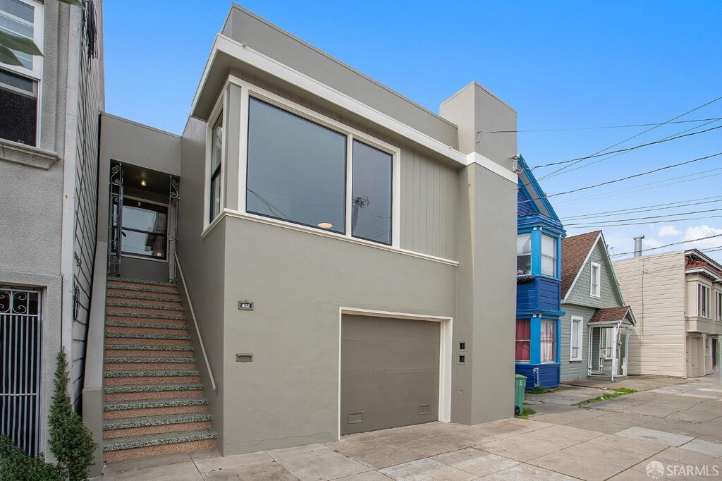 view of front facade with stucco siding and an attached garage