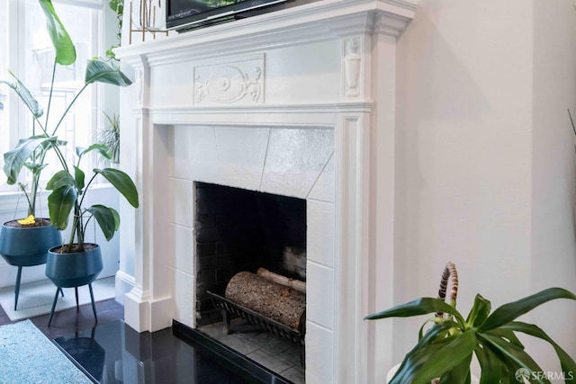 room details with concrete flooring and a tiled fireplace