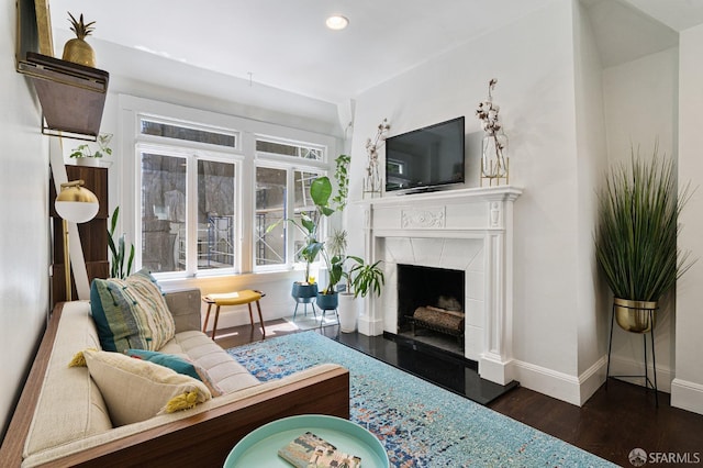 living room featuring dark hardwood / wood-style floors and a fireplace