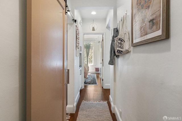 hall featuring dark hardwood / wood-style flooring and a barn door