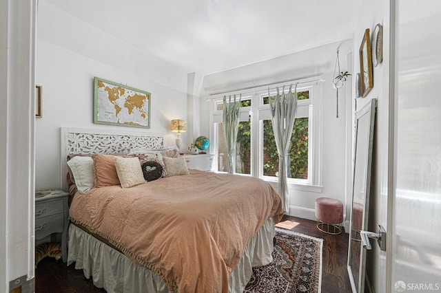 bedroom with dark wood-type flooring