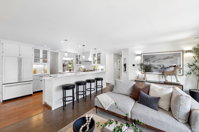living area featuring radiator heating unit, recessed lighting, and wood finished floors