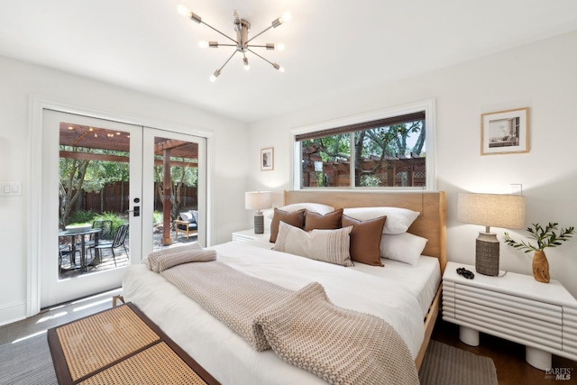 bedroom featuring a notable chandelier, access to exterior, and french doors