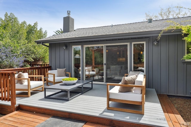 wooden terrace with an outdoor hangout area