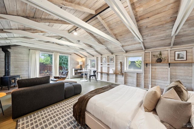 bedroom with wood walls, vaulted ceiling with beams, and a wood stove