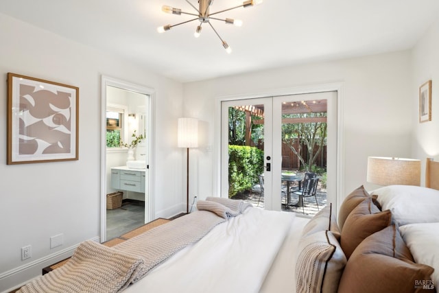 bedroom with baseboards, an inviting chandelier, ensuite bath, french doors, and access to exterior