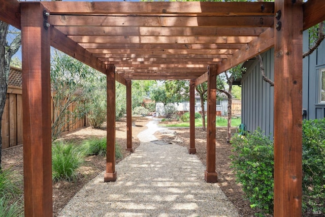 view of home's community with a patio, a pergola, and fence