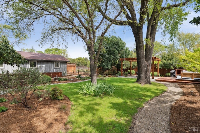 view of yard with a pergola, a wooden deck, and fence