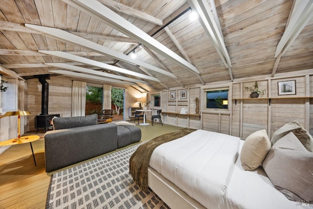 bedroom featuring wooden ceiling, lofted ceiling with beams, a wood stove, wooden walls, and wood finished floors
