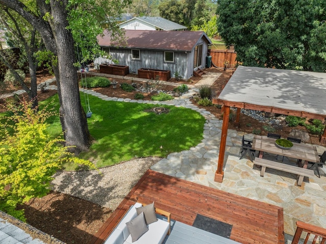 view of yard with a patio, fence, and a hot tub