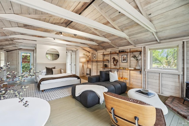 bedroom with wooden ceiling, wooden walls, access to exterior, vaulted ceiling with beams, and hardwood / wood-style floors