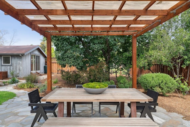 view of patio with outdoor dining space, a pergola, and fence