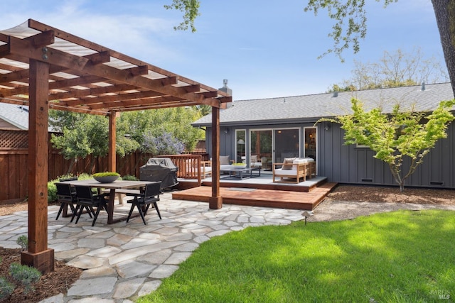 back of house featuring board and batten siding, a wooden deck, a pergola, fence, and outdoor dining space