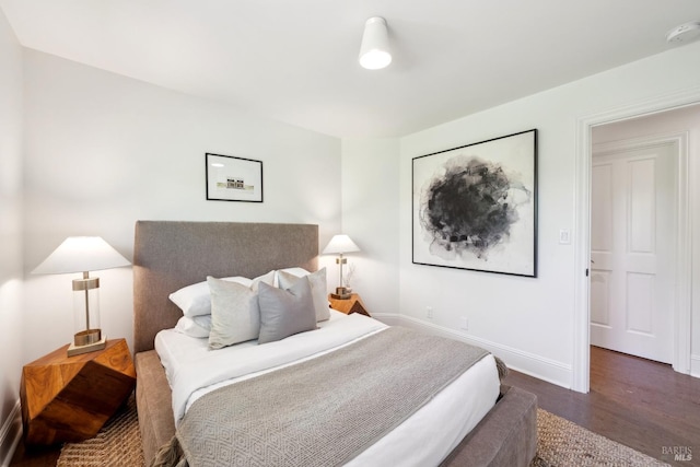 bedroom featuring baseboards and wood finished floors