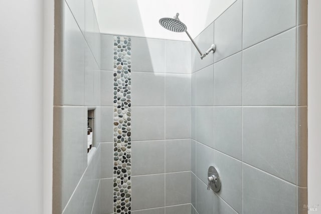 bathroom with tiled shower
