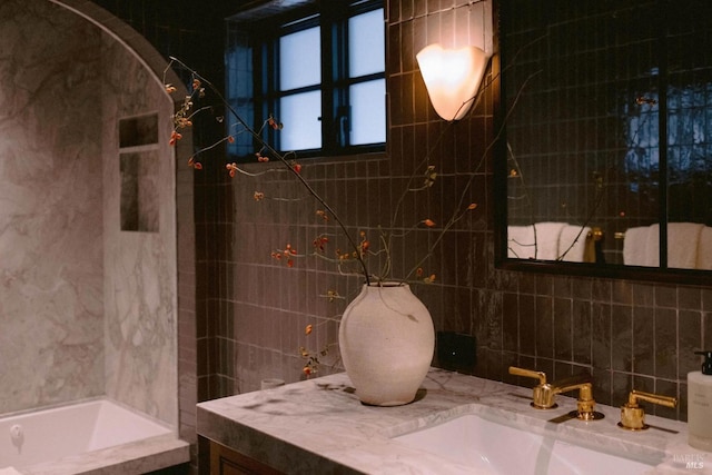 bathroom featuring tile walls and vanity