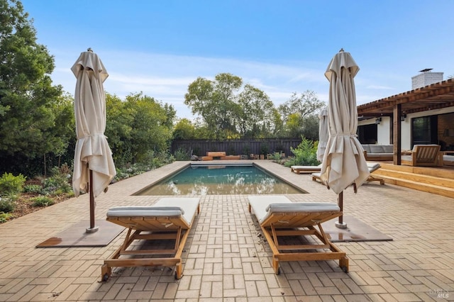 view of pool featuring a patio area, a fenced backyard, and a fenced in pool