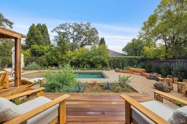 view of swimming pool with a patio area, a fenced backyard, a fenced in pool, and a wooden deck