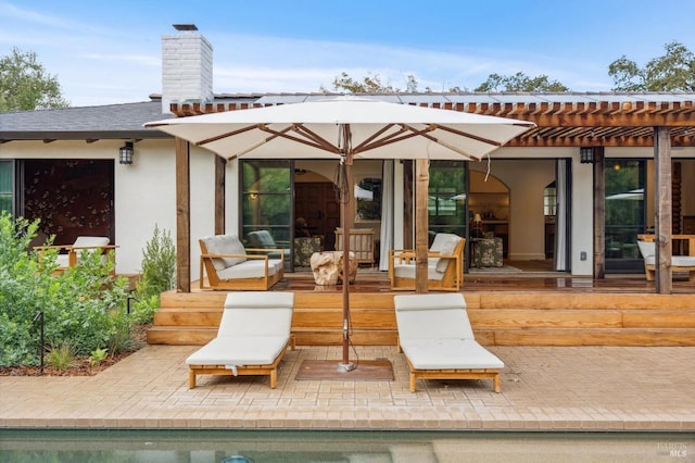 back of house with a patio, a shingled roof, a chimney, and a pergola