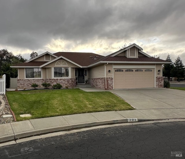 view of front of property with a front lawn and a garage