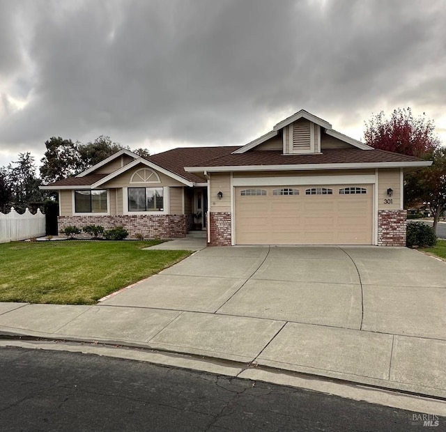 view of front of property featuring a front lawn and a garage