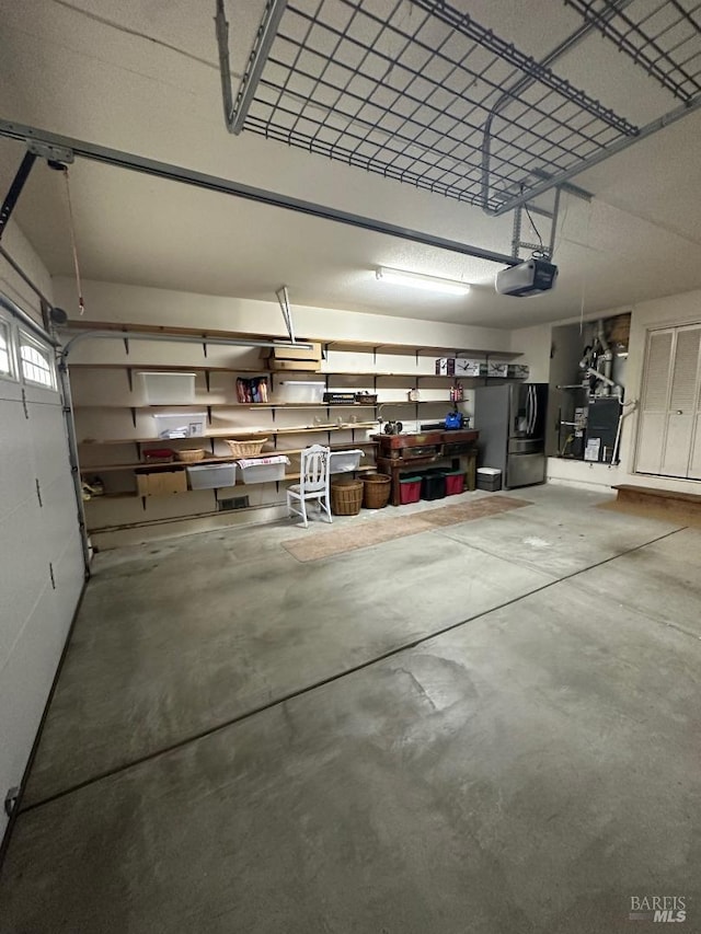 garage featuring a garage door opener and stainless steel fridge