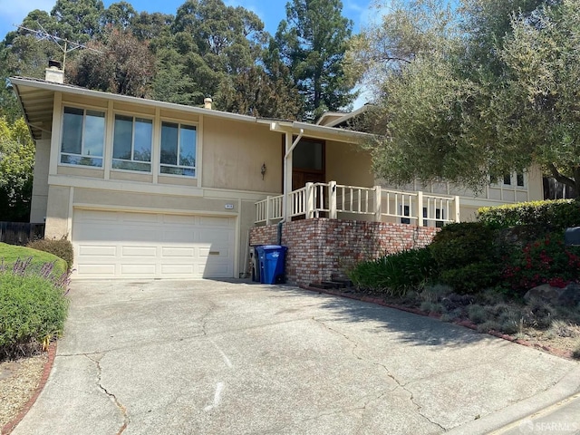 3410 Big Oak Ct, Hayward, CA 94542 - view of front of home with concrete driveway, a chimney, and an attached garage