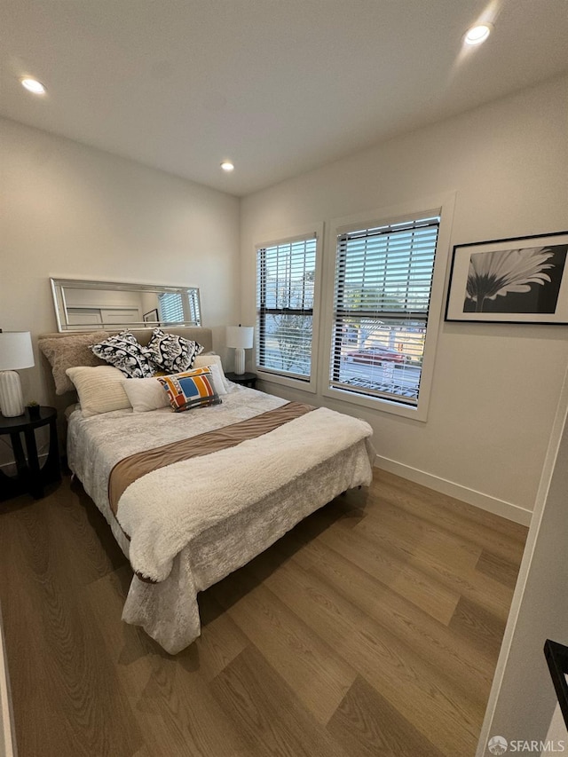 bedroom with recessed lighting, baseboards, and wood finished floors