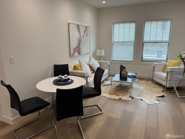 living area with recessed lighting, baseboards, and wood finished floors