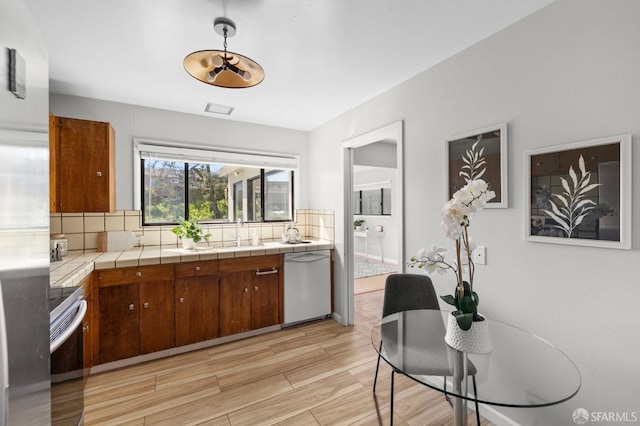 458 Alhambra Rd, South San Francisco, CA 94080 - kitchen with stainless steel electric range oven, white dishwasher, tile countertops, and tasteful backsplash