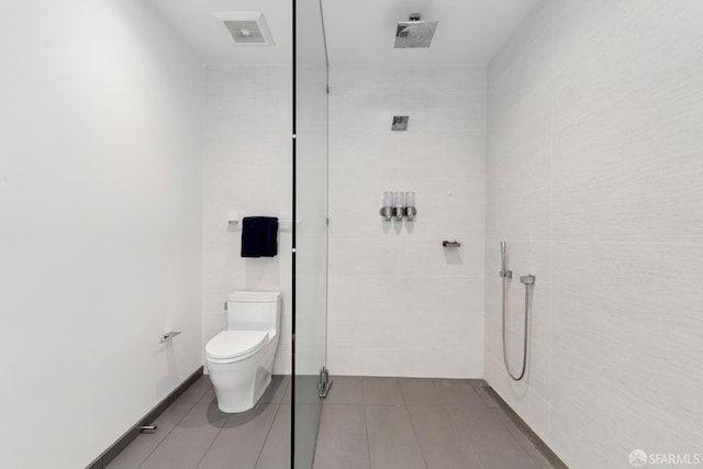 131 Missouri St Unit 402, San Francisco, CA 94107 - bathroom featuring a tile shower, toilet, tile patterned floors, and tile walls