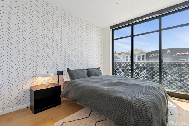 131 Missouri St Unit 402, San Francisco, CA 94107 - bedroom with wood finished floors, expansive windows, baseboards, and wallpapered walls