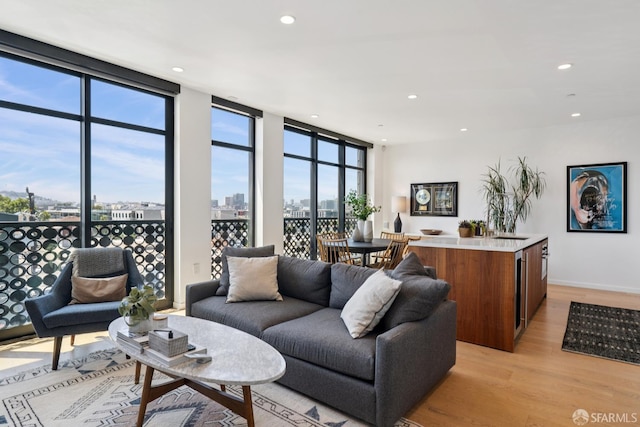 131 Missouri St Unit 402, San Francisco, CA 94107 - living room with light wood-type flooring, expansive windows, recessed lighting, a view of city, and baseboards