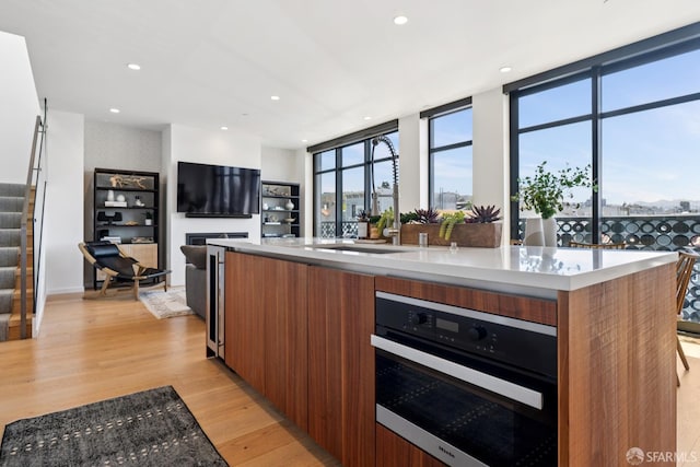 131 Missouri St Unit 402, San Francisco, CA 94107 - kitchen with modern cabinets, brown cabinetry, stainless steel oven, healthy amount of natural light, and recessed lighting