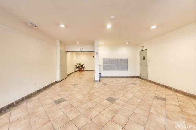 spare room with recessed lighting, mail area, baseboards, and light tile patterned floors