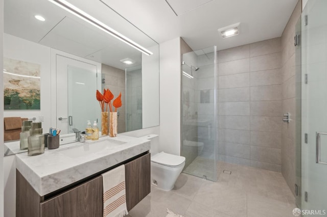 full bath featuring toilet, vanity, and a shower stall