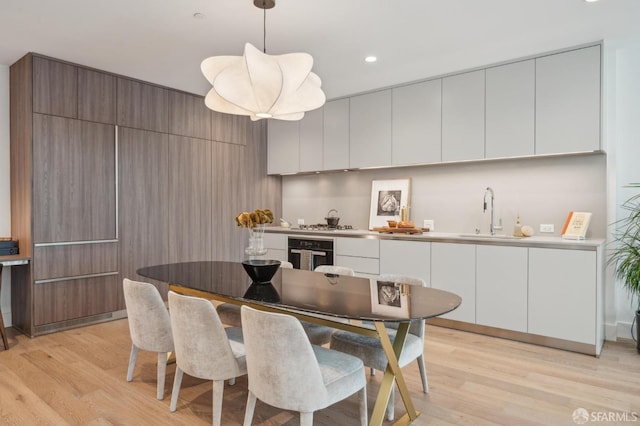 dining space featuring recessed lighting and light wood finished floors