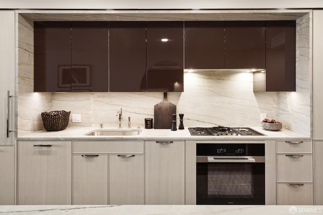 kitchen featuring backsplash, stainless steel appliances, and sink