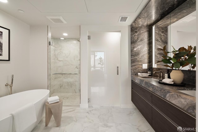 bathroom with vanity and independent shower and bath