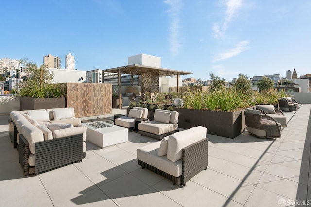 view of patio with an outdoor living space with a fire pit