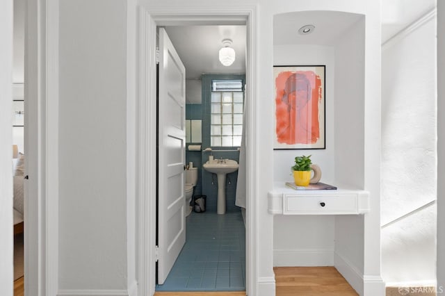 62 Manchester St, San Francisco, CA 94110 - corridor with a sink, baseboards, and light wood-style floors
