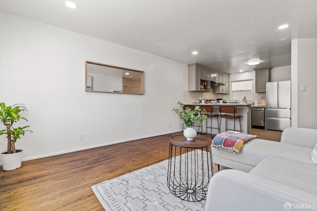 living room featuring dark wood-style floors, baseboards, and recessed lighting