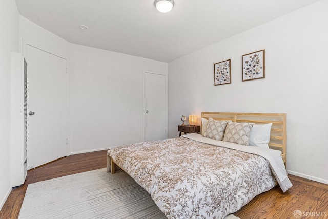 bedroom with wood finished floors and baseboards