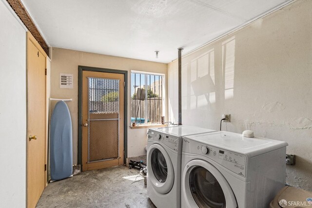 clothes washing area with laundry area and washer and clothes dryer