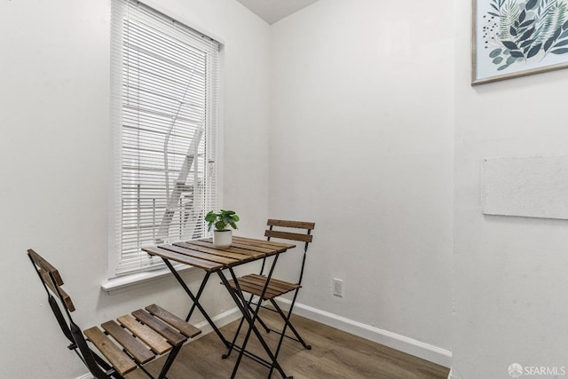 dining space featuring baseboards and wood finished floors