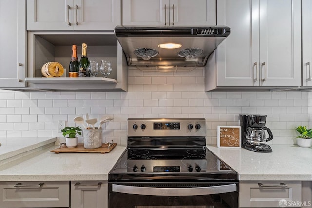 kitchen featuring black range with electric cooktop, light stone countertops, range hood, decorative backsplash, and open shelves