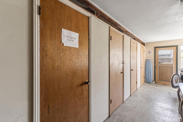 hall featuring concrete flooring