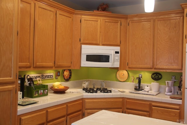 kitchen with light countertops and white appliances