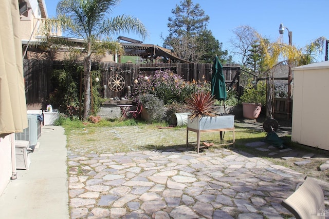 view of patio with central air condition unit and a fenced backyard