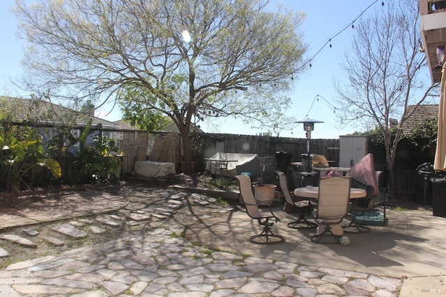 view of patio with a fenced backyard and outdoor dining area